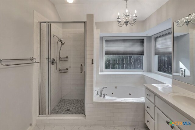 105 Legend Dr, Victoria, TX 77904 - full bathroom featuring a stall shower, a whirlpool tub, vanity, and a chandelier