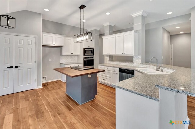 105 Legend Dr, Victoria, TX 77904 - kitchen with stainless steel appliances, wooden counters, a peninsula, white cabinetry, and a sink