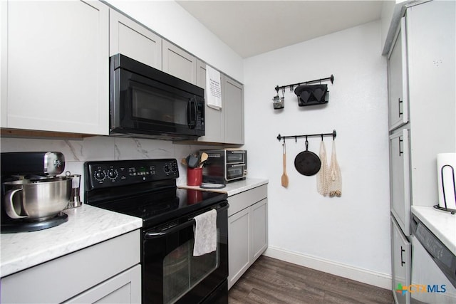 kitchen featuring tasteful backsplash, black appliances, and light countertops