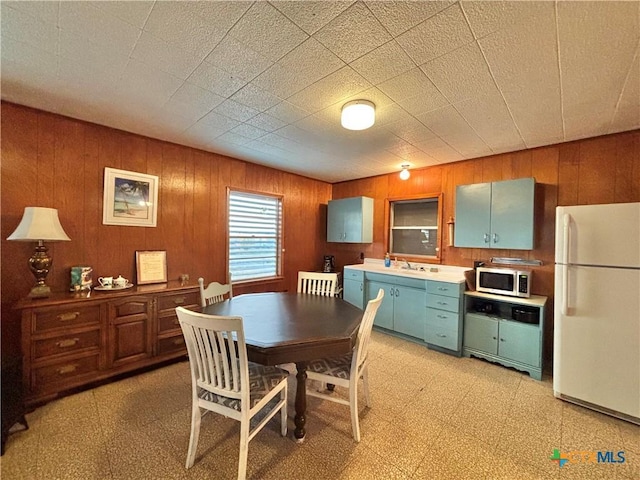 dining room featuring wood walls