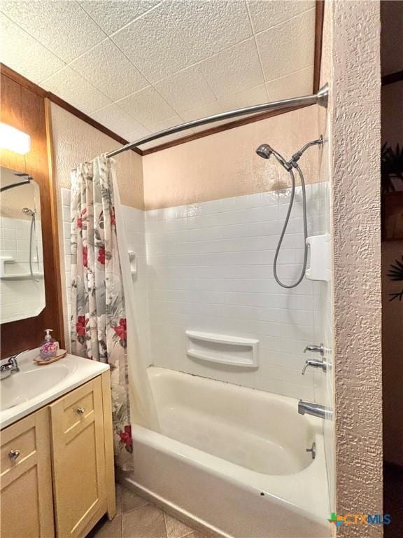 bathroom featuring tile patterned flooring, vanity, a textured ceiling, and shower / tub combo