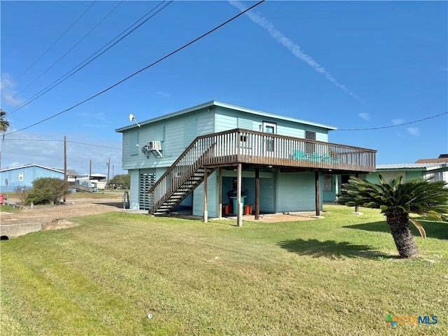 back of house featuring a yard and a wooden deck