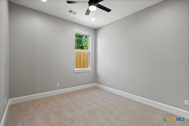 carpeted spare room featuring ceiling fan