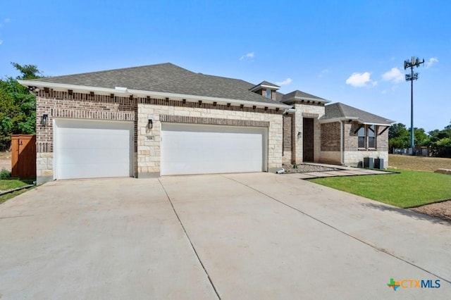 view of front facade with a garage and a front lawn