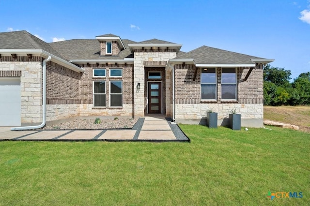 back of property featuring a lawn and a garage