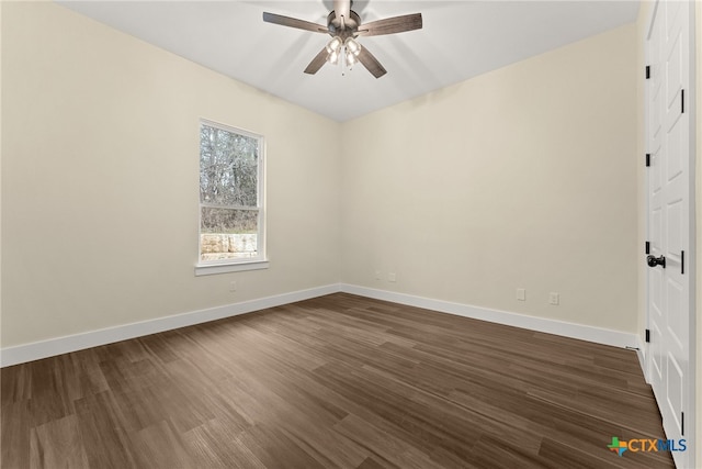 empty room featuring dark wood-style floors, baseboards, and a ceiling fan