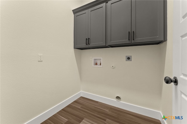 laundry room with gas dryer hookup, hookup for an electric dryer, washer hookup, baseboards, and cabinet space