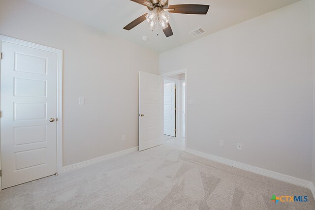 unfurnished room featuring ceiling fan and light carpet