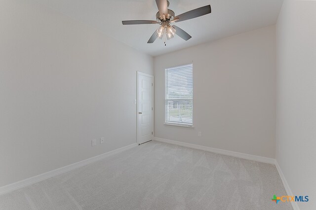 empty room with light carpet and ceiling fan