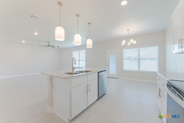 kitchen with a wealth of natural light, white cabinetry, and appliances with stainless steel finishes