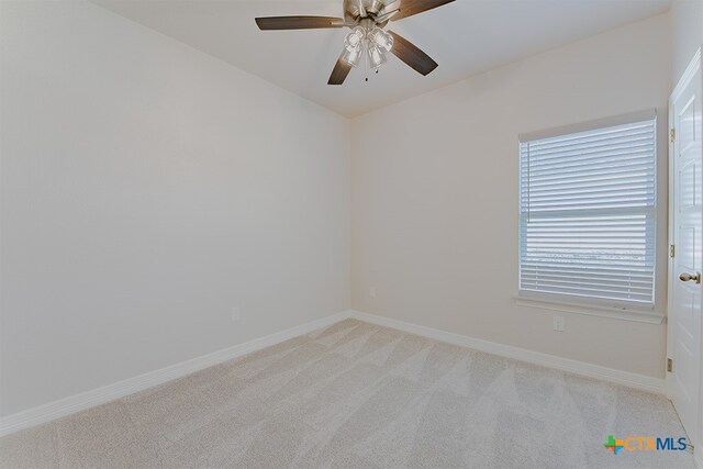 unfurnished room with light carpet and ceiling fan