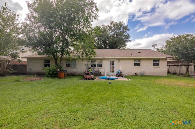 203 Yorkshire Ln, Victoria, TX 77904 - rear view of house featuring a patio area and brick siding