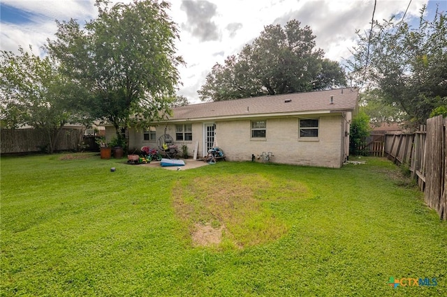 203 Yorkshire Ln, Victoria, TX 77904 - rear view of house featuring a patio area, a fenced backyard, and brick siding