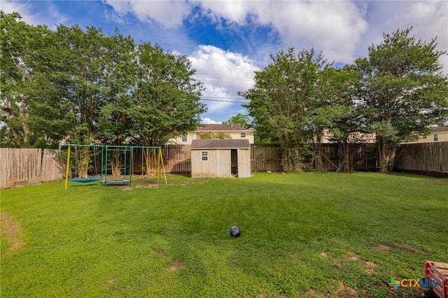 203 Yorkshire Ln, Victoria, TX 77904 - fenced backyard featuring a playground and a storage unit