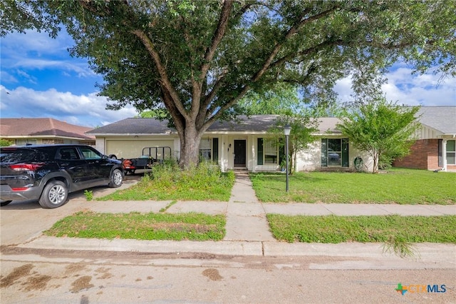 203 Yorkshire Ln, Victoria, TX 77904 - ranch-style home with an attached garage, a front yard, and concrete driveway