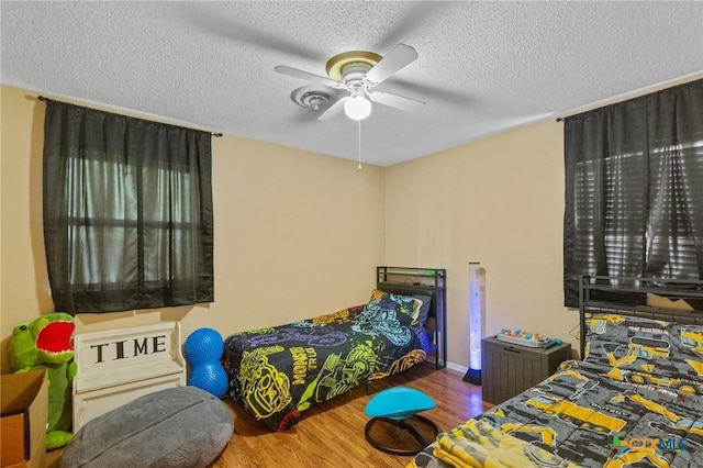 203 Yorkshire Ln, Victoria, TX 77904 - bedroom featuring wood finished floors, a textured ceiling, and a ceiling fan