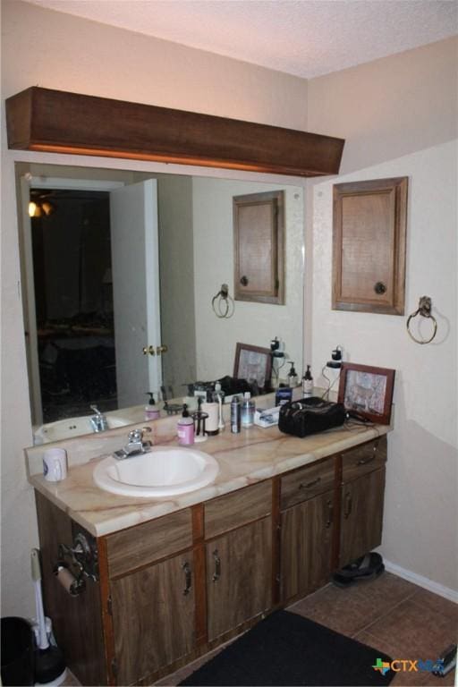 bathroom featuring tile patterned floors, vanity, and baseboards