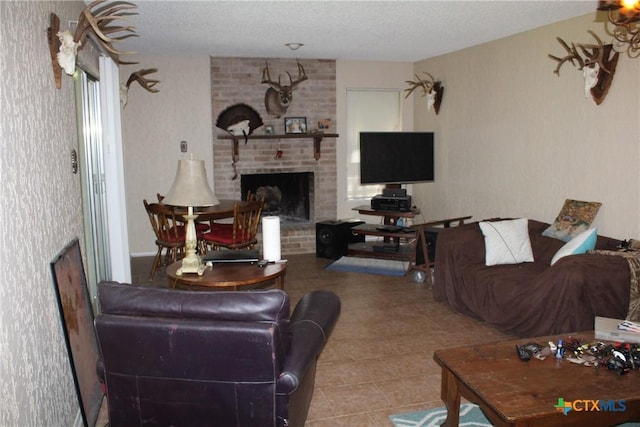 tiled living area with a brick fireplace and a textured ceiling