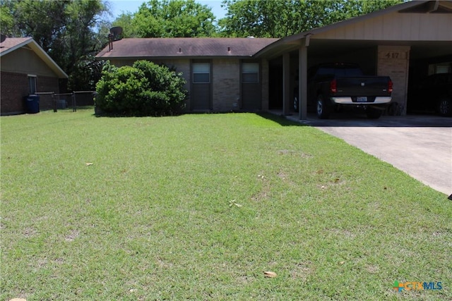 view of yard featuring an attached carport and driveway