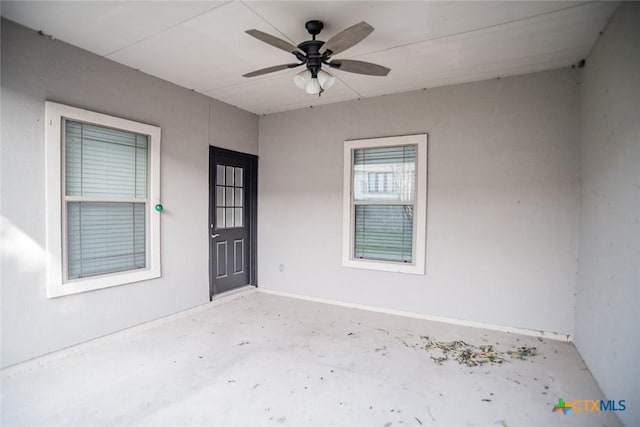 property entrance featuring stucco siding and ceiling fan