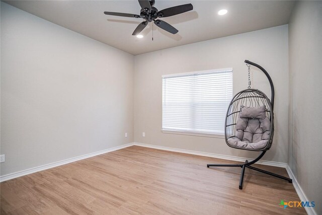 unfurnished room with recessed lighting, baseboards, and wood finished floors