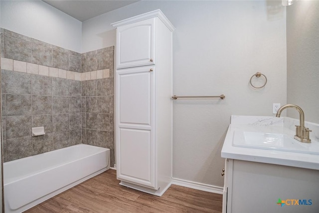 bathroom featuring vanity, baseboards, and wood finished floors