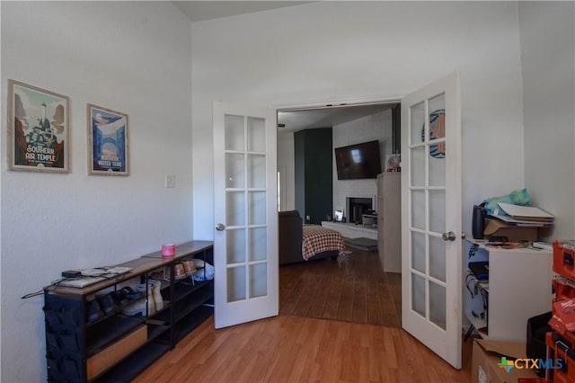 hallway with french doors and wood finished floors