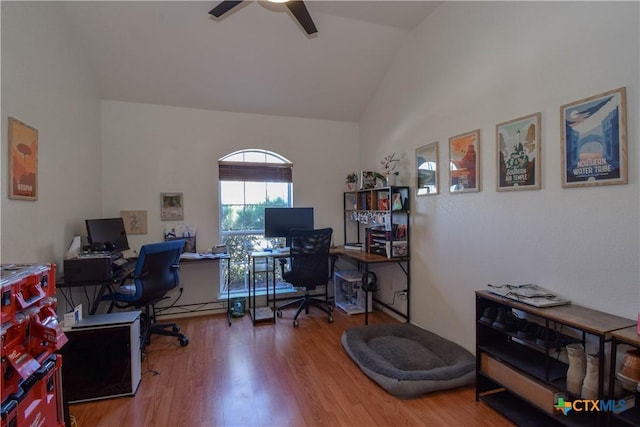 home office featuring ceiling fan, vaulted ceiling, and wood finished floors