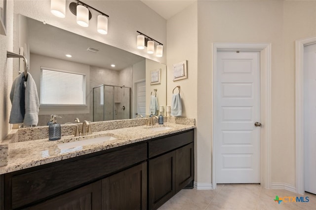 3301 Amerigo Pl, Round Rock, TX 78665 - bathroom featuring a shower stall, double vanity, and tile patterned floors