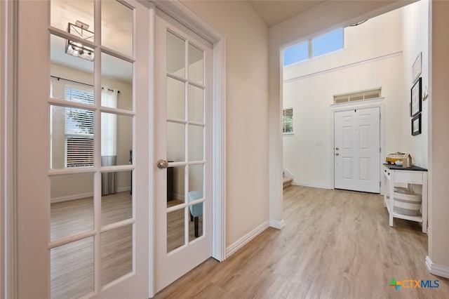 3301 Amerigo Pl, Round Rock, TX 78665 - entryway featuring french doors, light wood finished floors, stairs, and baseboards