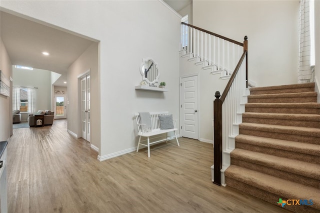 3301 Amerigo Pl, Round Rock, TX 78665 - stairway featuring wood finished floors, baseboards, recessed lighting, and a towering ceiling