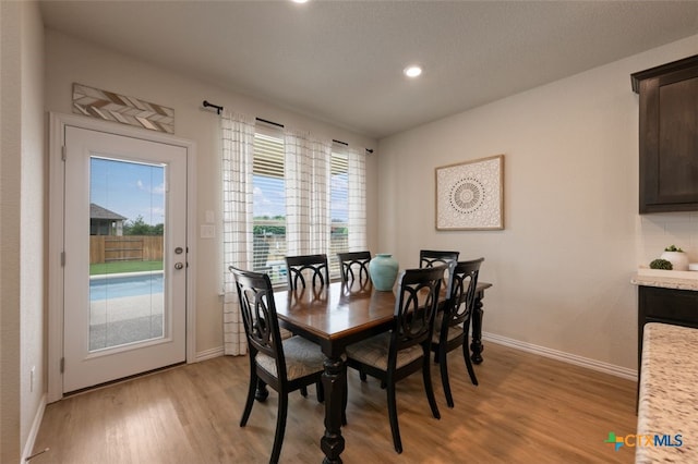 3301 Amerigo Pl, Round Rock, TX 78665 - dining area with light wood finished floors, baseboards, and recessed lighting