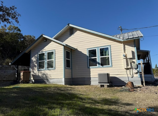 back of property featuring a yard