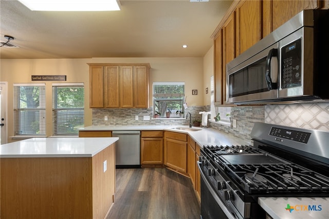 3416 Winding Shore Ln, Pflugerville, TX 78660 - kitchen featuring stainless steel appliances, dark wood-style floors, light countertops, backsplash, and a kitchen island