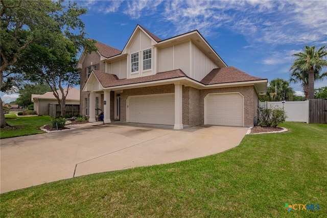 204 Edgewater, Victoria, TX 77904 - view of front of house featuring brick siding, concrete driveway, board and batten siding, an attached garage, and roof with shingles