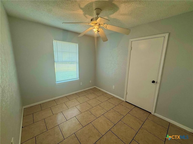 2102 Spicewood Dr, Killeen, TX 76543 - unfurnished bedroom with light tile patterned flooring, a textured ceiling, and a ceiling fan