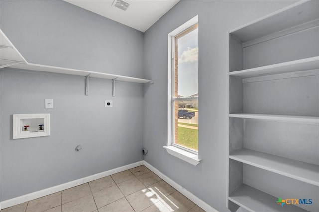 508 Taurus Dr, Killeen, TX 76542 - laundry room with washer hookup, electric dryer hookup, baseboards, and tile patterned floors