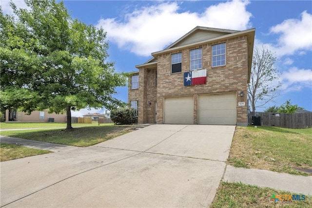 508 Taurus Dr, Killeen, TX 76542 - traditional-style home with brick siding, a garage, concrete driveway, and central AC unit