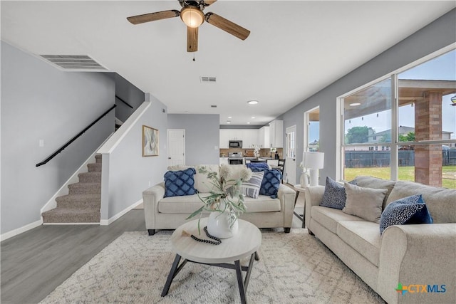 508 Taurus Dr, Killeen, TX 76542 - living room featuring light wood finished floors, stairs, baseboards, a ceiling fan, and recessed lighting