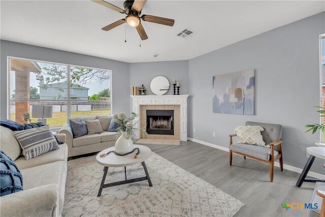 508 Taurus Dr, Killeen, TX 76542 - living room with wood finished floors, a ceiling fan, baseboards, and a fireplace