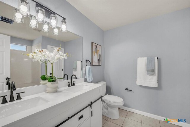 508 Taurus Dr, Killeen, TX 76542 - full bathroom featuring double vanity, tile patterned floors, toilet, and baseboards