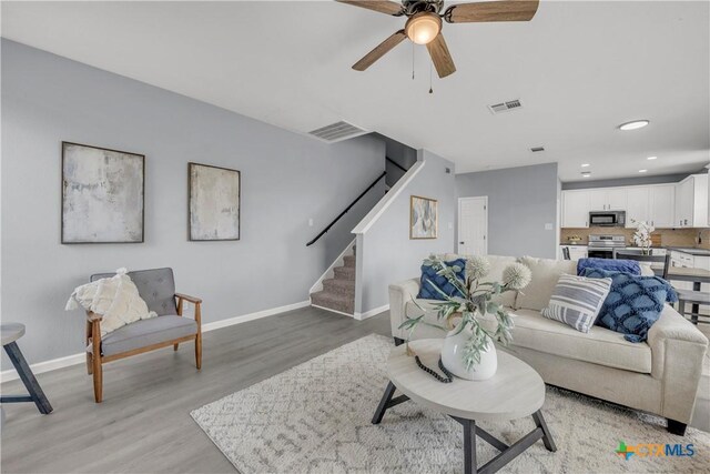 508 Taurus Dr, Killeen, TX 76542 - living room with stairs, a ceiling fan, baseboards, light wood finished floors, and recessed lighting