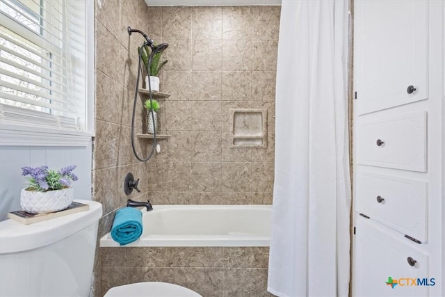 full bathroom featuring tiled shower / bath and toilet