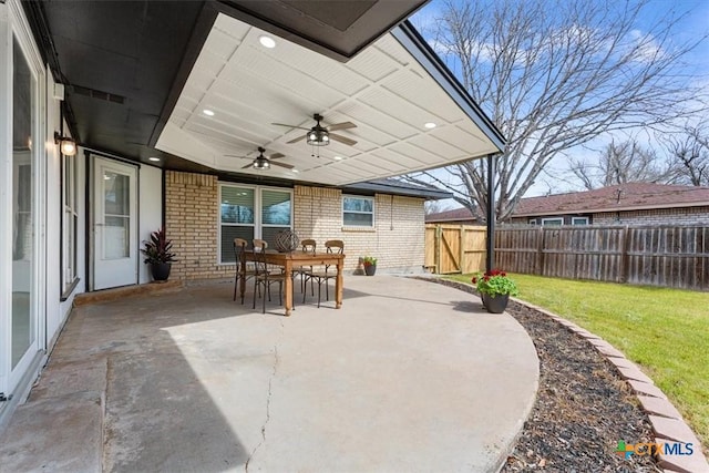 view of patio / terrace with ceiling fan and fence