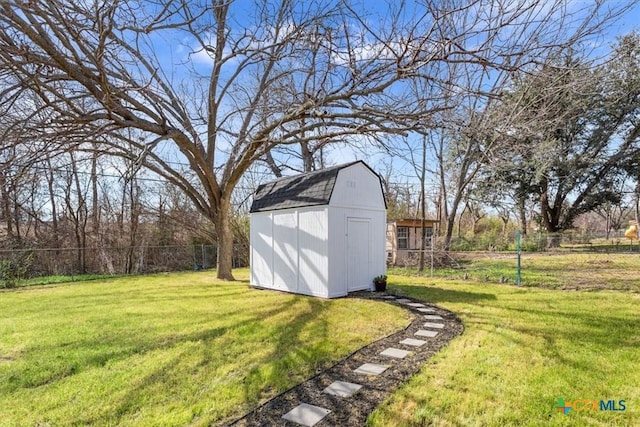 view of yard with an outbuilding, fence, and a storage shed