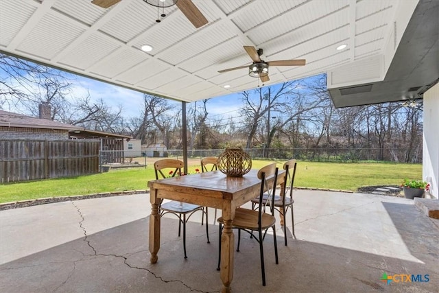 view of patio with outdoor dining area, a fenced backyard, and ceiling fan