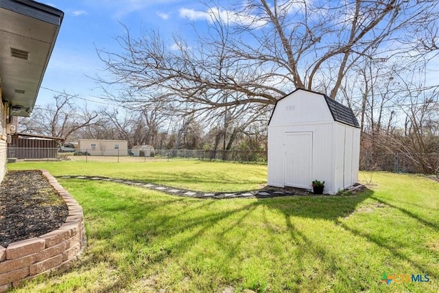 view of yard featuring an outdoor structure, a storage shed, and fence