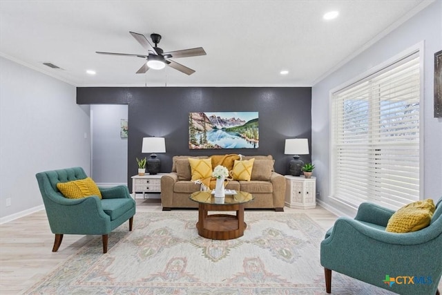 living room featuring recessed lighting, an accent wall, visible vents, baseboards, and crown molding