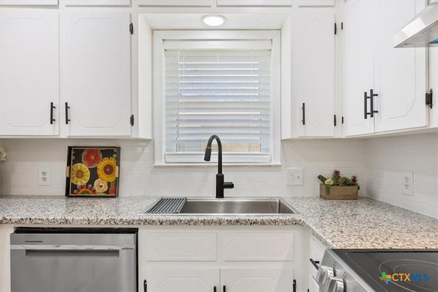 kitchen with appliances with stainless steel finishes, range hood, white cabinetry, and a sink