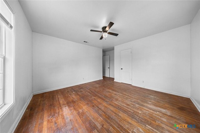 1304 E French Ave, Temple, TX 76501 - unfurnished bedroom featuring baseboards, hardwood / wood-style flooring, and ceiling fan